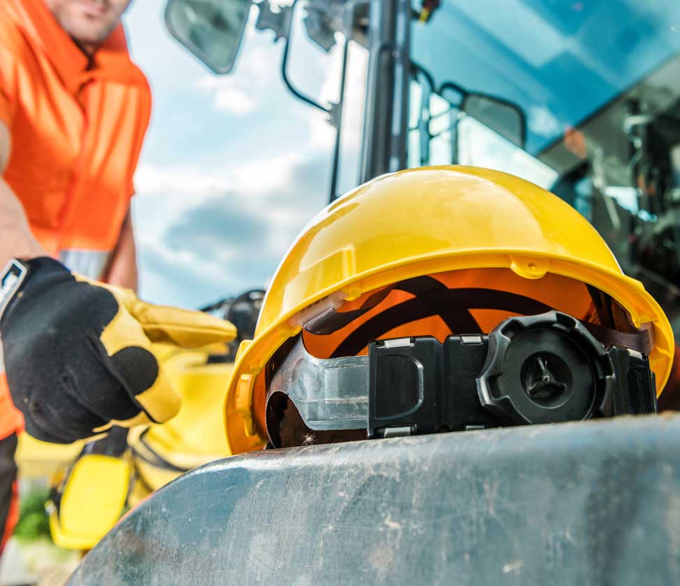 Photo of a man reaching for his hard hat